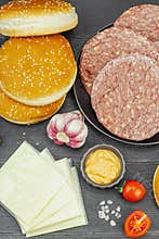 Burger patties. Beef cutlets, buns, vegetables and sauce. Homemade American classic