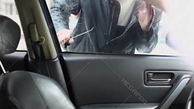 Man in leather jacket tries to break door lock of