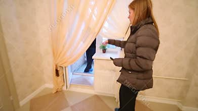 Real estate agent showing a man room and a balcony