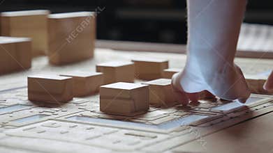 Hands of Professional Man Constructing Architecture Model of Urban City Building