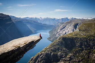 Man sitting on trolltunga in norway