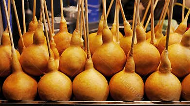 Roll of traditional Thai local dessert snack, deep fried dough called Pong Neng or corn dog, candy bomb for sell as street food in