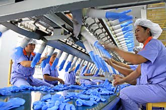 Female workers on the acrylonitrile butadiene gloves production