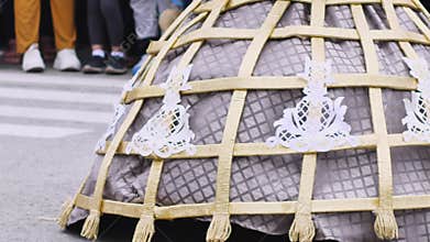 Woman in festive dress with golden decor dances at festival