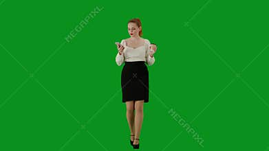 Portrait of attractive office girl on chroma key green screen. Woman in skirt and blouse walking drinking coffee from