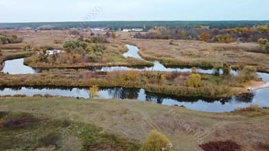 Aerial view on river curve in autumn valley