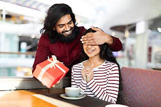 Handsome bearded eastern man make his girlfriend birthday surprise