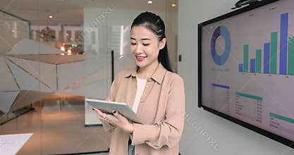 Asian female analyst using digital tablet in office