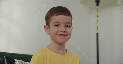 Portrait at home indoors little school boy cute son pupil schoolboy child kid male baby schoolkid orphan smiling looking