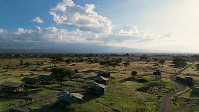 Top view of tent camp on the background of Mount Kilimanjaro in the African savannah. Tents in the forest in Africa