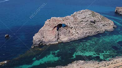 Natural windows in the rocks, Comino Island Malta, Establishing drone shot