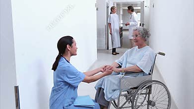 Nurse looking at a patient in a wheelchair