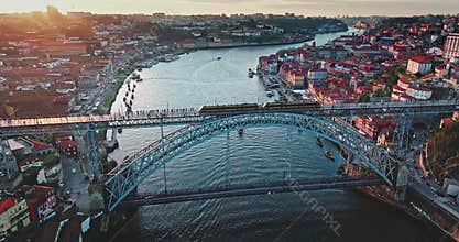 Porto city skyline with Dom Luis I Bridge over Douro River at sunset
