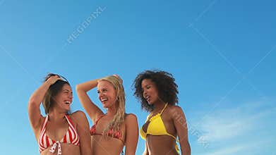 Three dancing friends in their bikinis