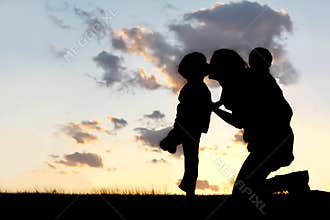 Mother and Two Young Children Hugging and Kissing