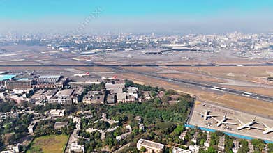 Wide aerial shot of Mumbai\'s Chhatrapati Shivaji Maharaj International Airport runways, taxiways.