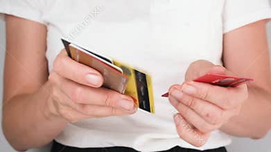Close up of a woman sorting through plastic cards in her hands, searching for one. Concept of shopping, finance, banking
