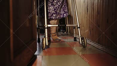 Old woman making efforts in walking around the