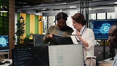Programmers in office automating workflows using artificial intelligence tech