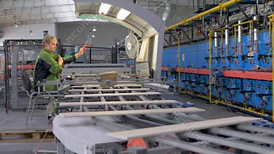 Technician managing conveyor system in tile production facility