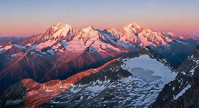 Majestic Snow Capped Mountain Range at Sunrise with Alpenglow Panorama