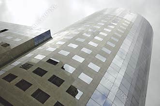 Modern corporate high rise building with reflective glass windows and contemporary urban architecture exterior design