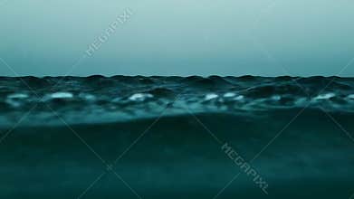 Teal ocean water with ripples under misty sky