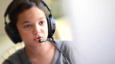 Child happy listen music and playing on the computer with headphones outdoor