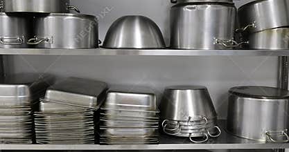 Details with stainless steel kitchen pots, pans and utensils in a professional canteen or hospital kitchen