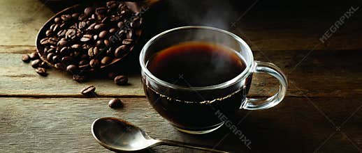 Close up of freshly brewed coffee in a glass mug with coffee beans