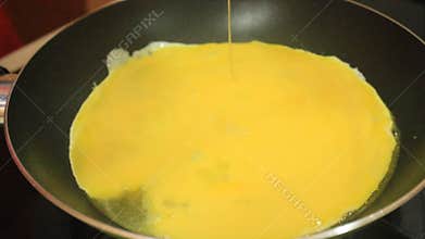 Someone fried a beaten egg. Cooking fried eggs