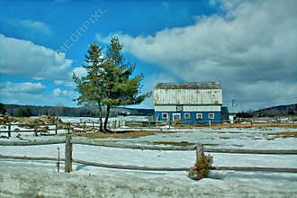 Winter landscape in the countryside with a barn