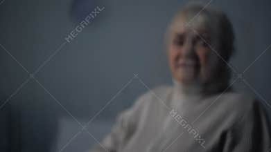 Depressed senior woman deeply crying on rainy day, old age problems, loneliness