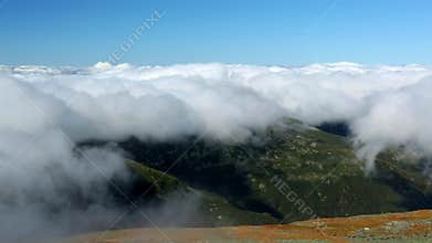 Mount Washington peak stands above a thick layer of fluffy clouds