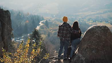Young tourist couple in love standing on the rocks and enjoy a beautiful view. Man and woman visiting famous tourist