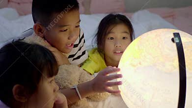 Children`s group learning about geography at bedroom.