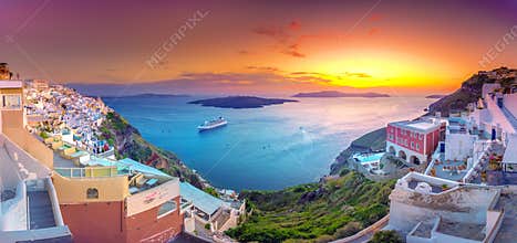 Oia town on Santorini island, Greece. Traditional and famous houses and churches with blue domes over the Caldera, Aegean sea