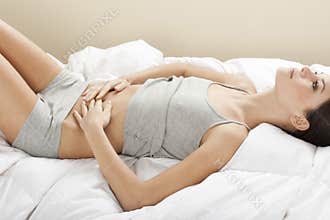 Young woman stroking her belly