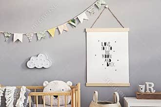 Stylish scandinavian nursery interior with hanging mock up poster, natural toys, teddy bears, children`s accessories and design