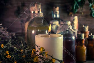 A witchery stuff: multiple tincture bottles, bunches of dry healthy herbs, stack of ancient ritual books, amulets, candles...