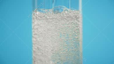 Pouring soda in glass blue background refreshing drink clean sparkling water