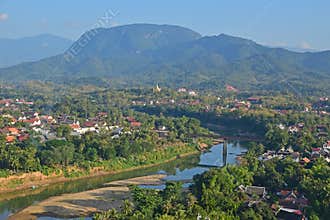 Local landmark of Luang Prabang overlooking the Nam Khan River and local neighborhood with mountains in the background