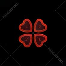 Heart shape red jellies contain letter LOVE on black background.