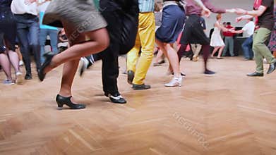 Dancers perform lindy hop dance at the swing festival. Dancing legs close up.