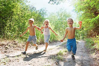 Happy kids running in the woods