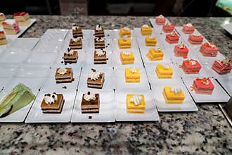 Assorted mini desserts lined up in neat rows