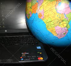 Illustrative editorial of Payoneer Master card and computer