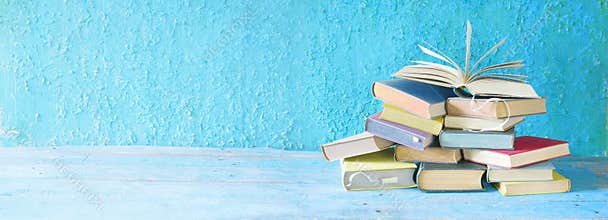 Open book on an stack of books.