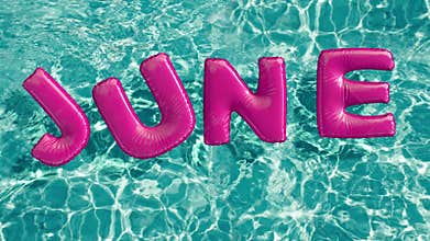 Word `JUNE` shaped inflatable swim ring floating in a refreshing blue swimming pool