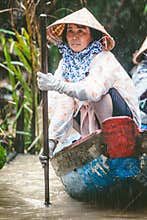 MEKONG, VIETNAM. Woman with her boat carrying tourists